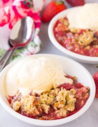 This bright blushing Fresh Strawberry Pistachio Crumble is the perfect summertime treat! It's an easy cobbler variation with a irresistible crumb topping!