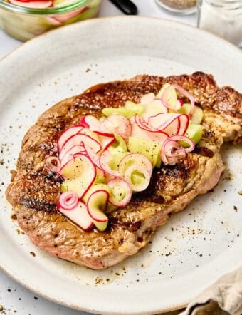 Best Steak Toppings - Steak on plate with pickled radish topping