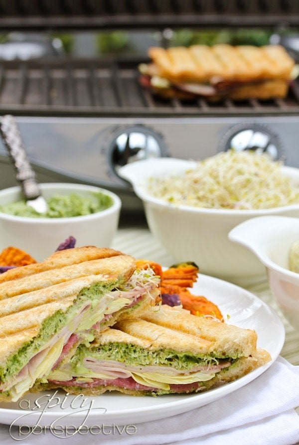 Hot Panini Sandwich with Creamy Pesto Sauce on a plate.