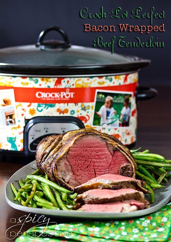 Crockpot Bacon Wrapped Beef Tenderloin Recipe with Balsamic Glaze sliced on platter with green beans