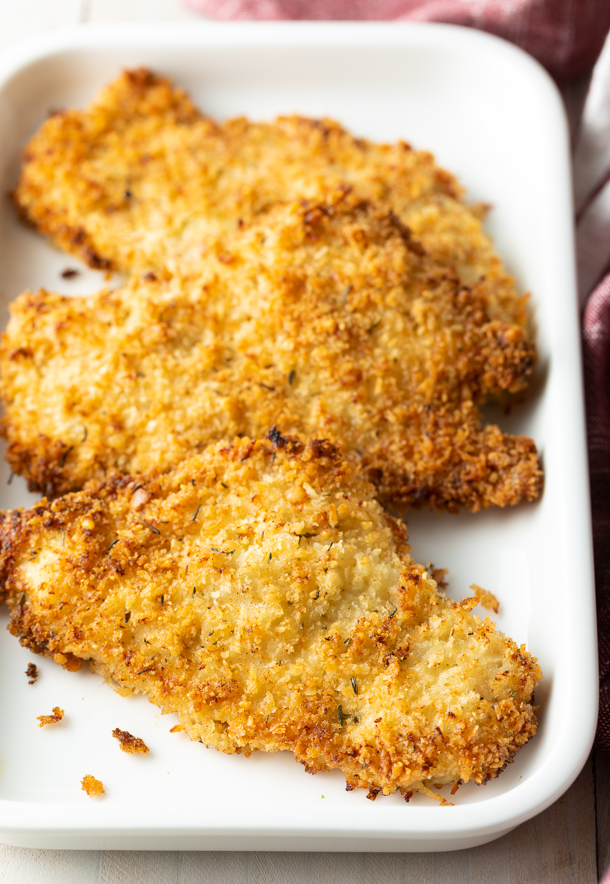 close up of Baked breaded chicken cutlets on platter