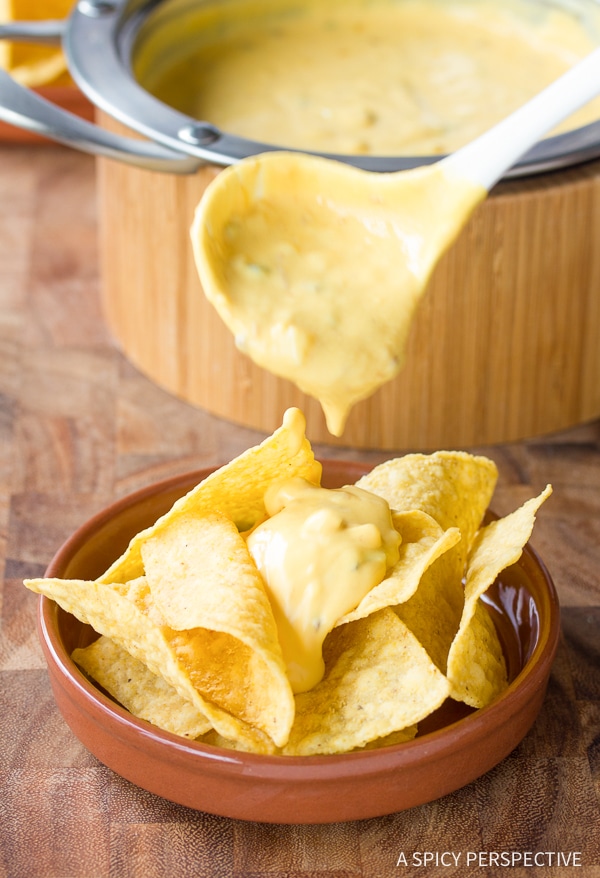 Cheese sauce makes or breaks any nacho recipe. The Best Queso recipe is easy and flavorful, with sharp and smoky notes. Start dipping those tortilla chips! #ASpicyPerspective #queso #cheese #dip 
