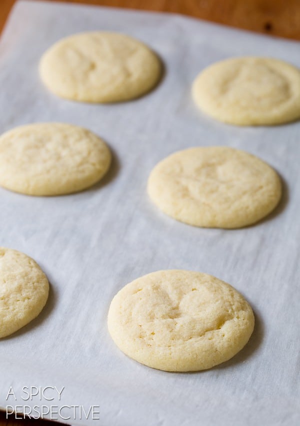 Baked sugar cornmeal cookies on parchment paper.