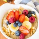 crockpot oatmeal with berries and banana slices on top