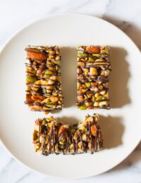 Awesome Kid-Friendly Paleo Nut Bar Recipe with Chocolate Drizzle on ASpicyPerspective.com #paleo #vegan #glutenfree