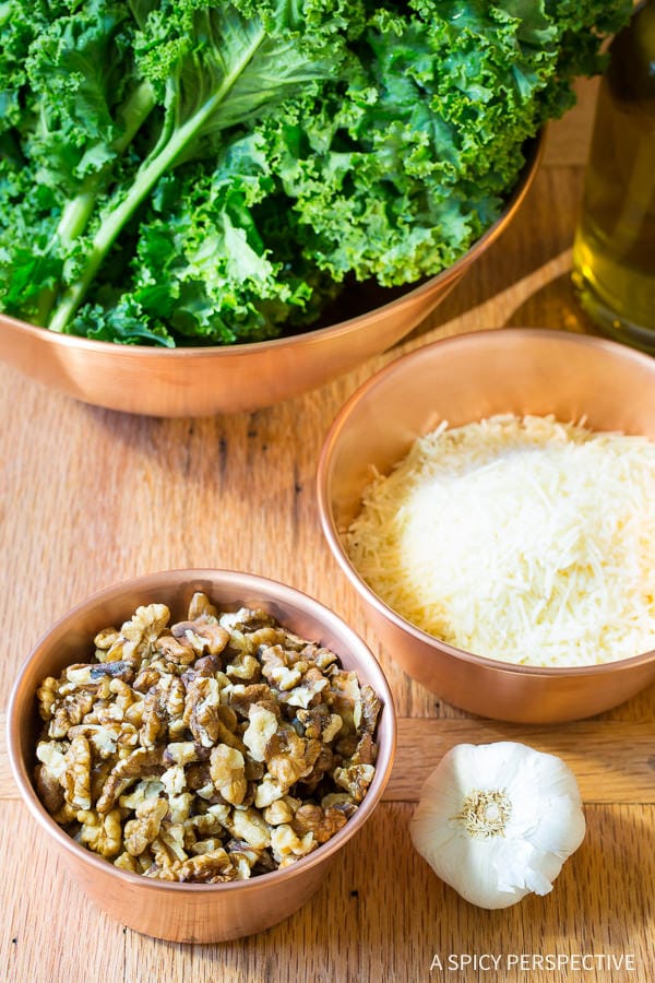 Making 5-Ingredient 5-Minute Kale Pesto Recipe on ASpicyPerspective.com #paleo #glutenfree #vegan