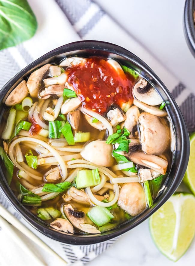Overhead shot of hot pot bowl with spicy hot sauce on top.