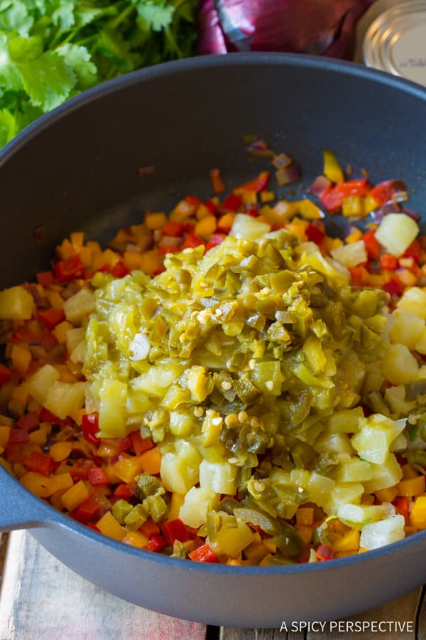 Pineapple, Green Chiles and Jalapenos #ASpicyPerspective #Rice #Caribbean #CaribbeanRice #CaribbeanRiceRecipe #ConfettiRice #SideDish #Jalapenos #Pineapple #BellPeppers #CoconutMilk