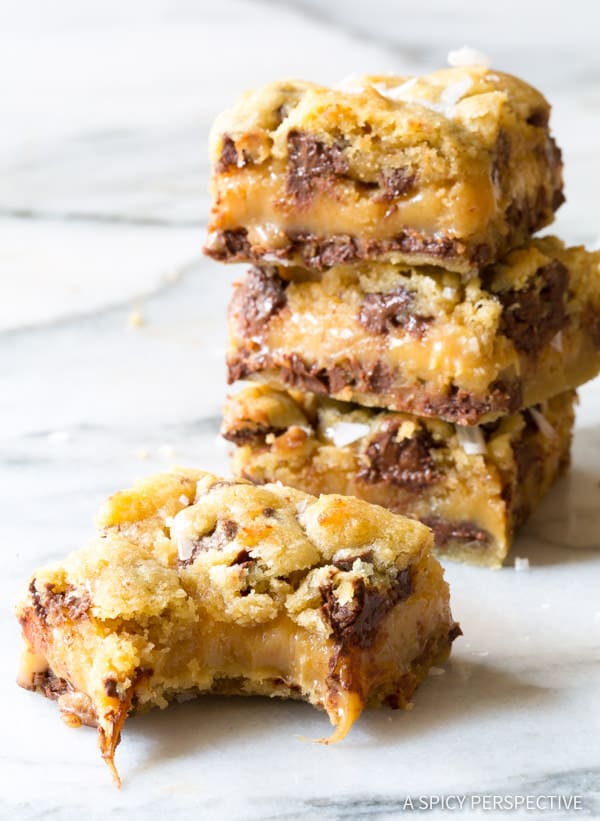 Chocolate Chip Cookie Bars recipe, with gooey caramel centers. This cookie bar recipe is so delicious, everyone will ask for the recipe. #ASpicyPerspective #cookiebars #cookies #chocolatechip #baking #dessert
