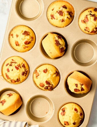 Corn Muffins Recipe - warm cornbread muffins in pan with bacon and maple syrup