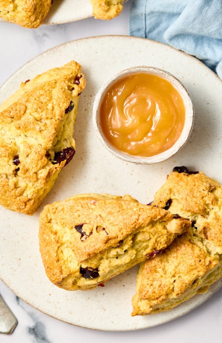 Walnut Cherry Scones on a plate with lemon curd