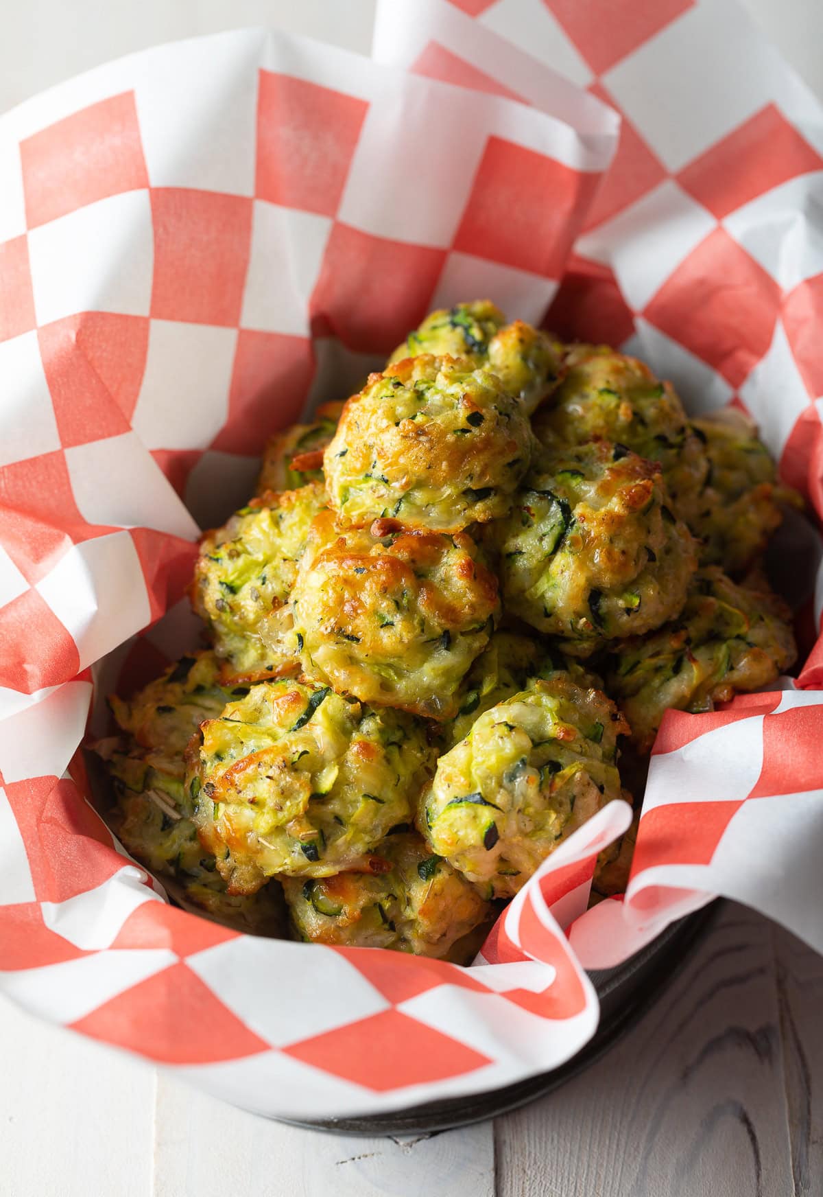 Baked zucchini tots in a basket.