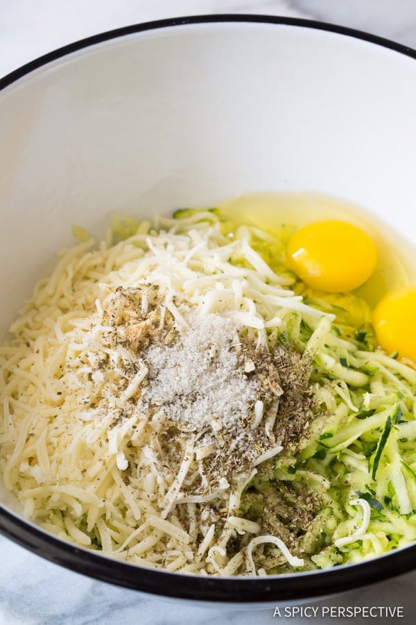 Ingredients for zucchini tots in mixing bowl.