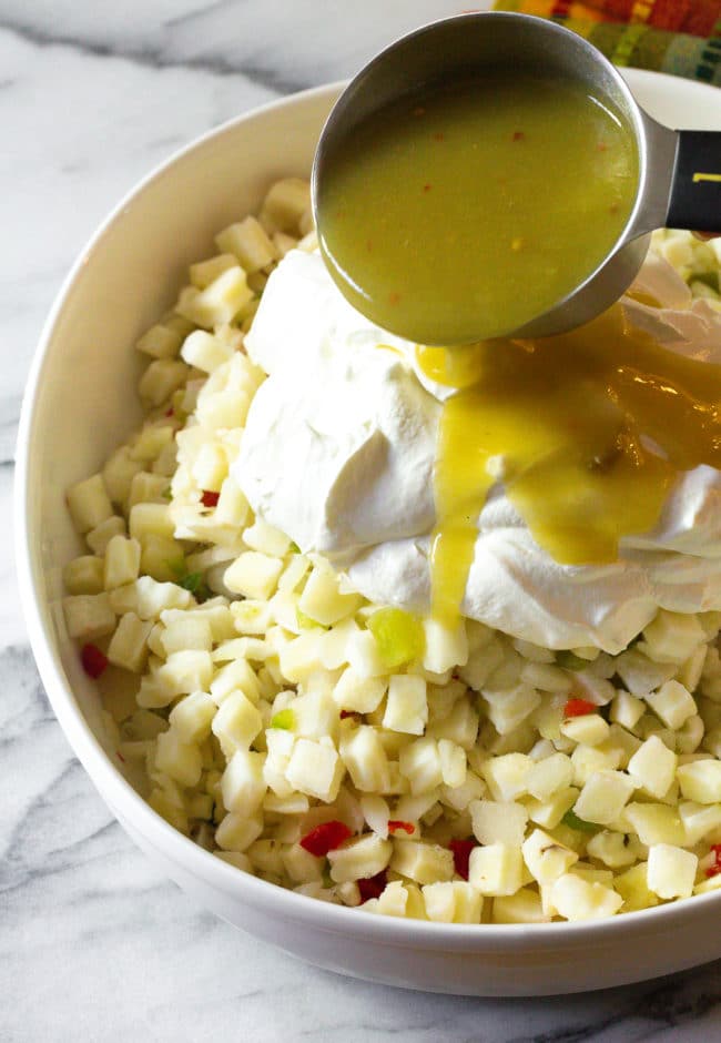 Ingredients being poured over potatoes, 