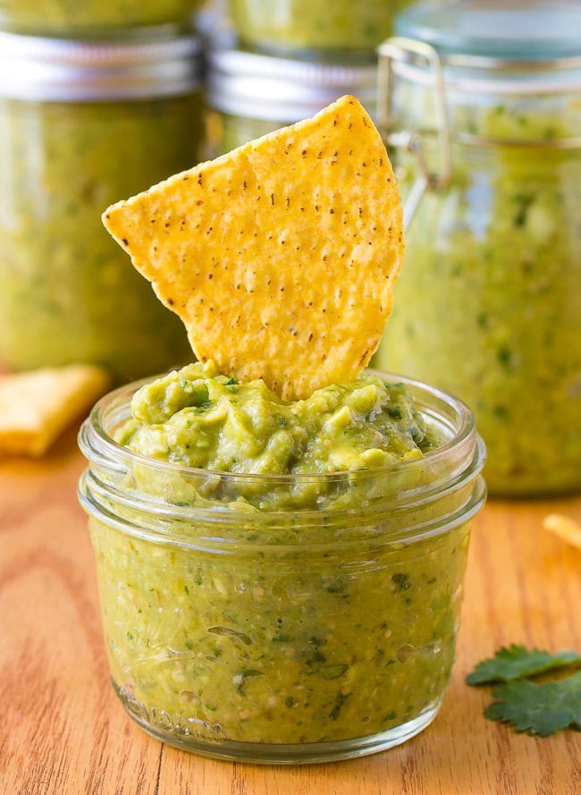 salsa verde recipe Small jar of salsa verde topped off with a tortilla chip.