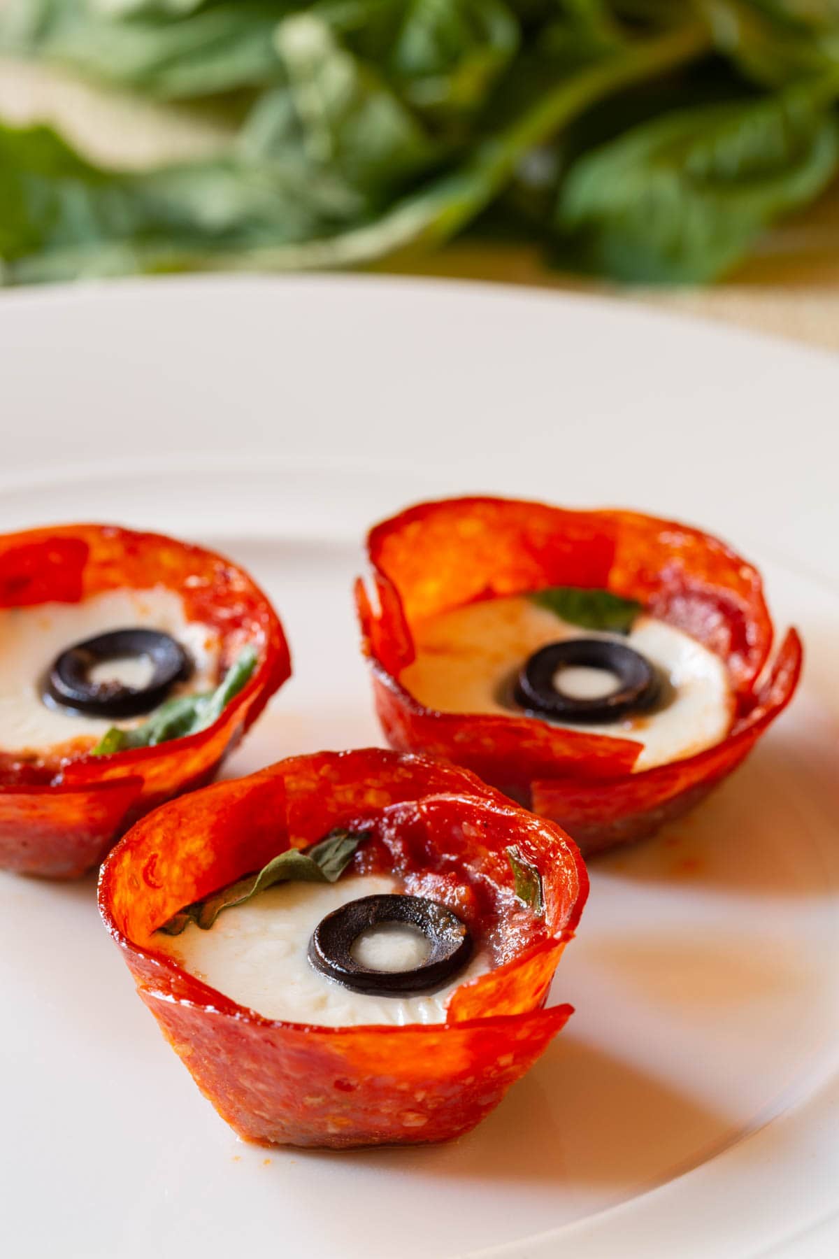 Plated pepperoni cups - close up shot with melted cheese