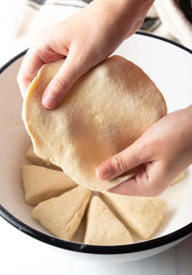 Pulling of the easy dough to make tortilla shapes 