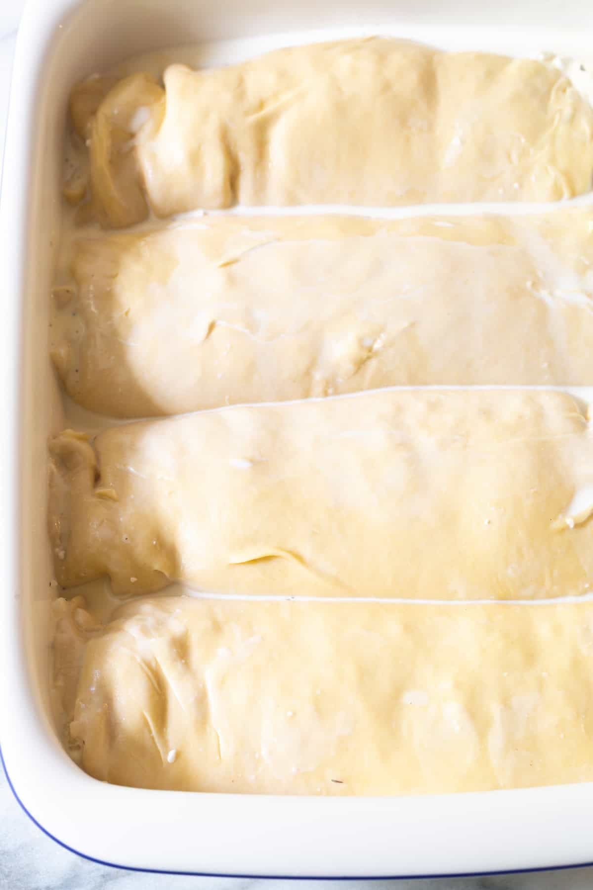 Unbaked strukli in a baking dish ready for oven.