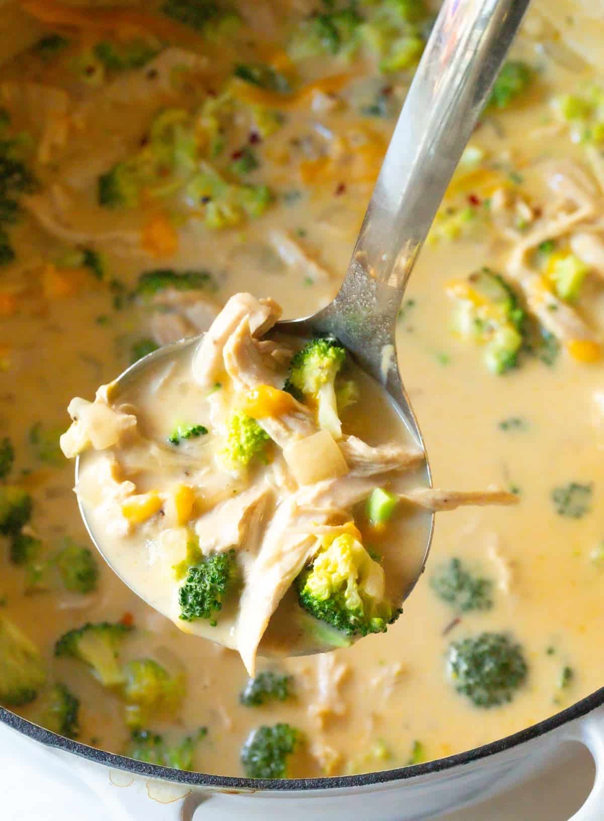 chicken broccoli soup in ladle over pot
