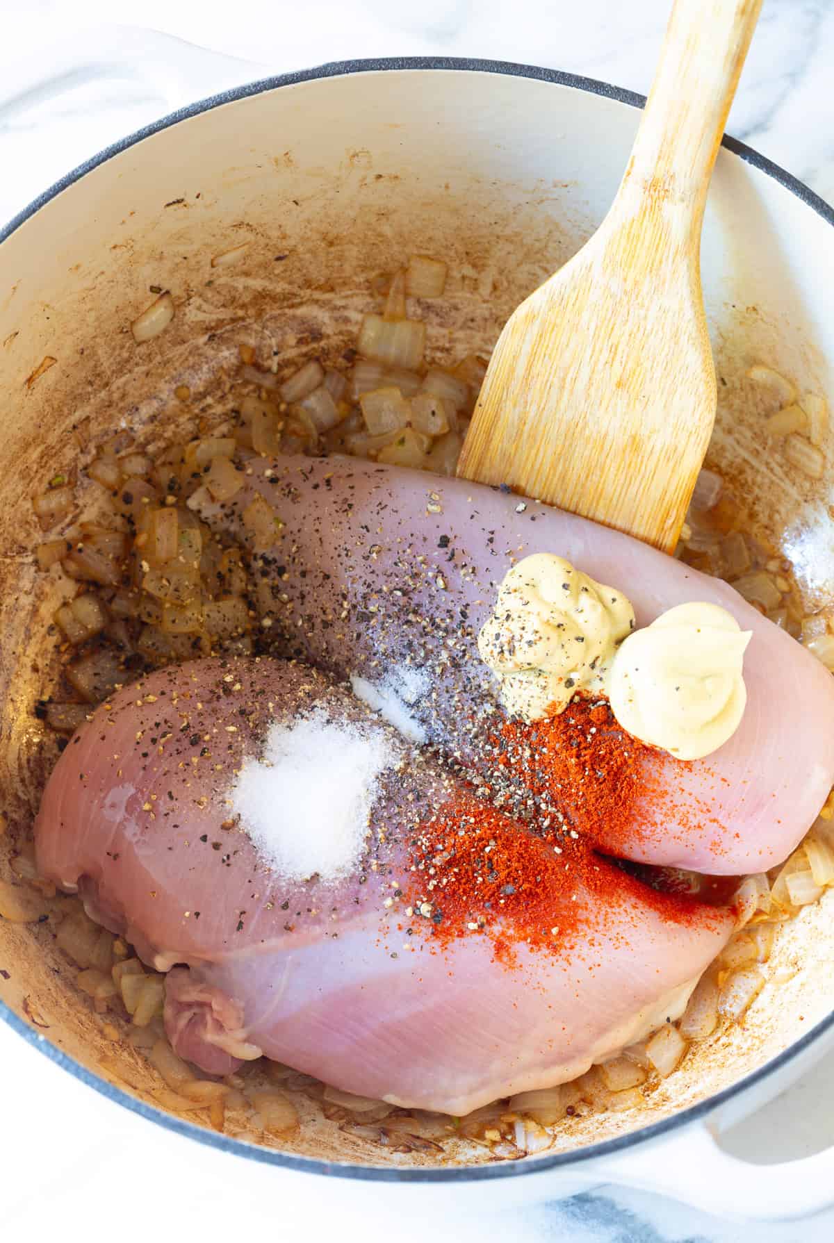 raw chicken and spices in pot