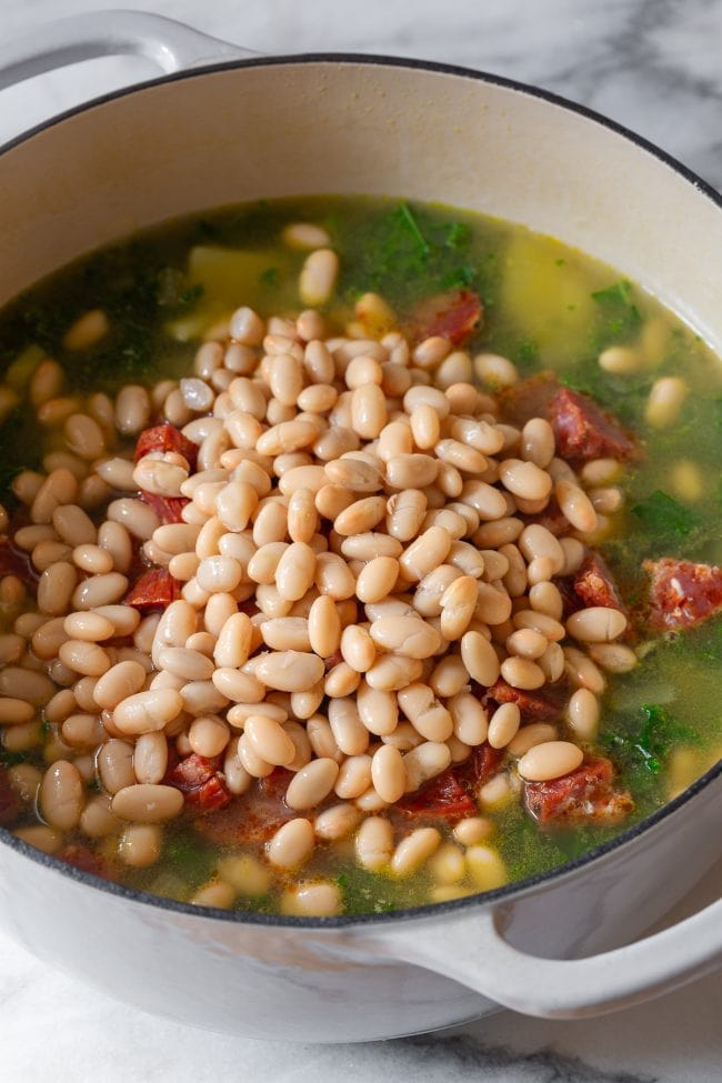 Portuguese bean soup - adding beans to pot
