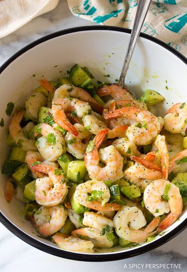 Top down view of bowl filled with ingredients for roasted shrimp salad.