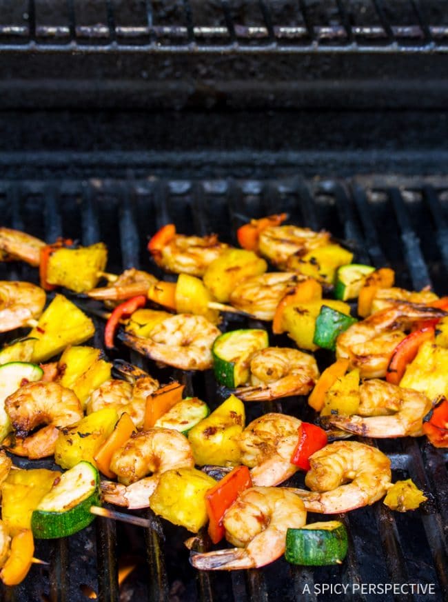 Shrimp skewers grilling on barbecue. 