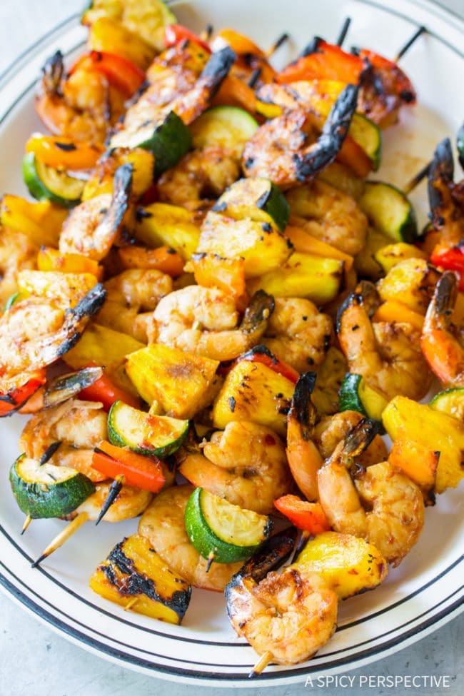Closeup of cooked skewers of grilled teriyaki shrimp. 
