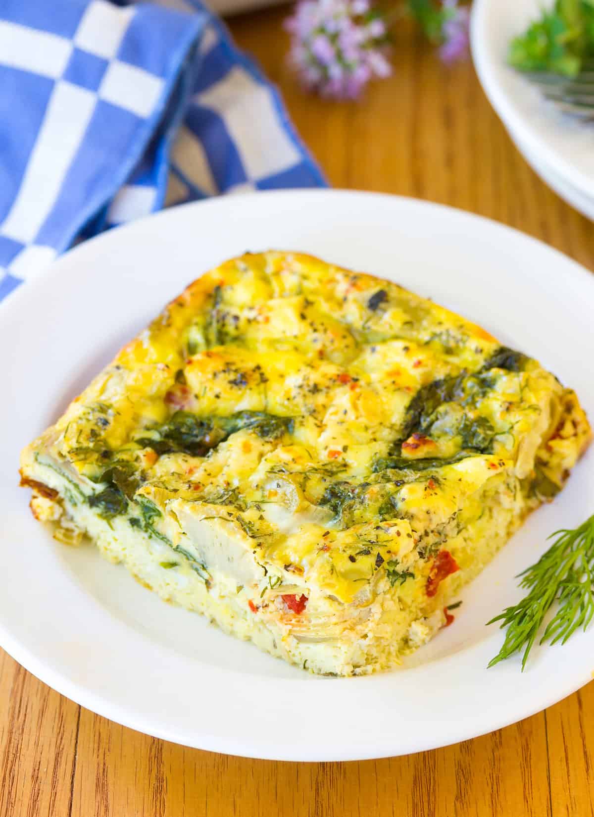 Greek Omelette Casserole recipe - cut and placed on white plate