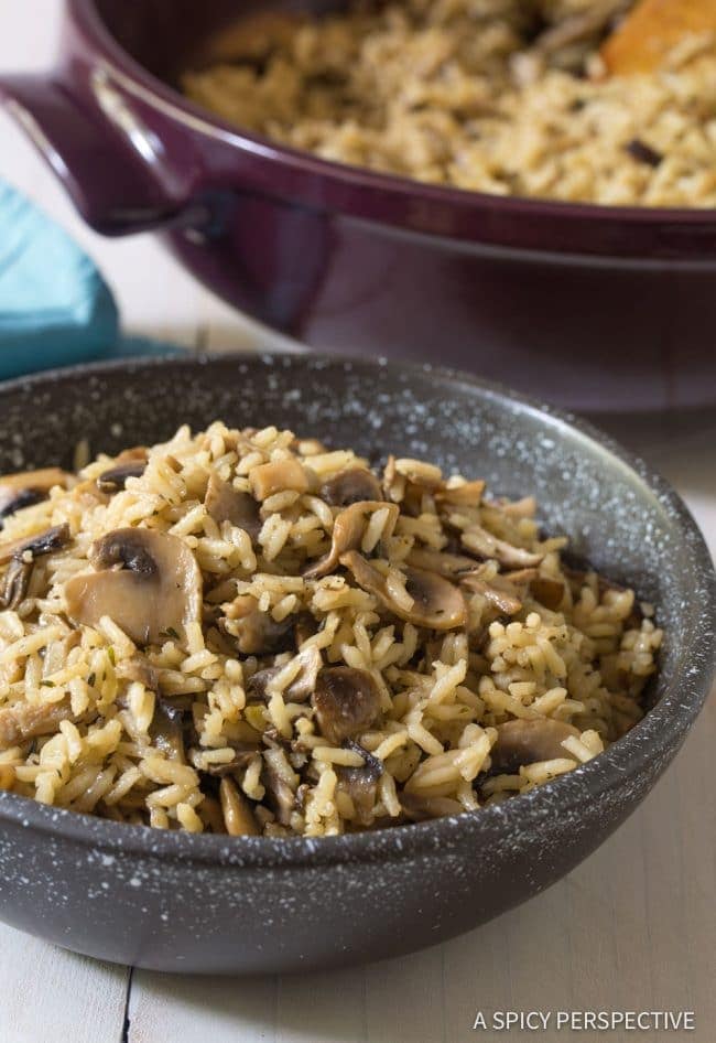 Closeup of mushroom rice pilaf in a black bowl.