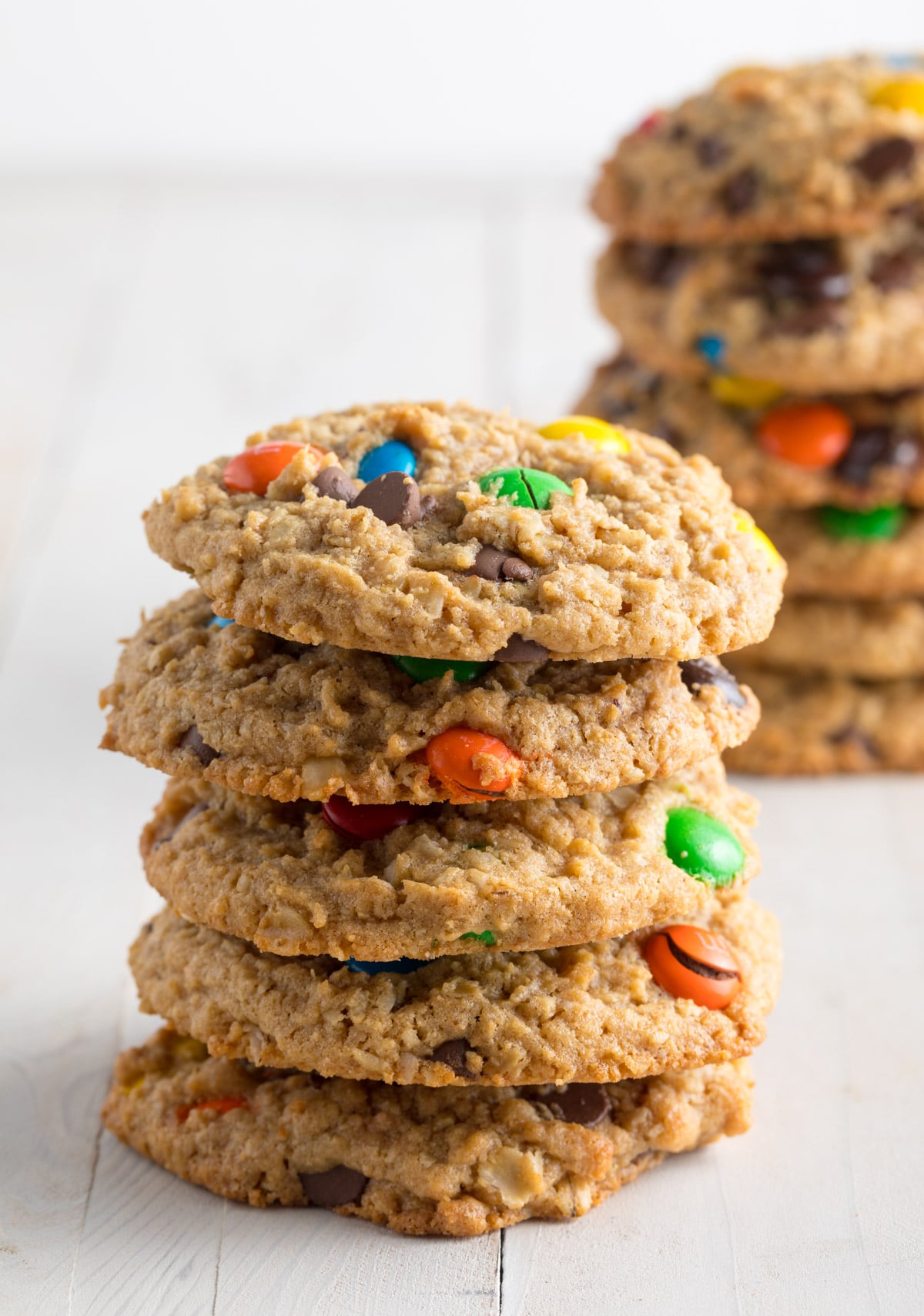 A stack of 5 monster cookies with m&m candies, peanut butter, and oats.