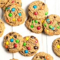 Top down view a dozen peanut butter oatmeal monster cookies with m&m candies.