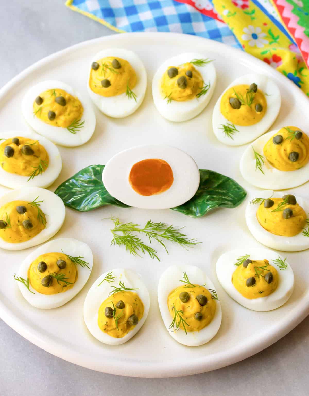 easy deviled eggs with caper and dill on egg platter