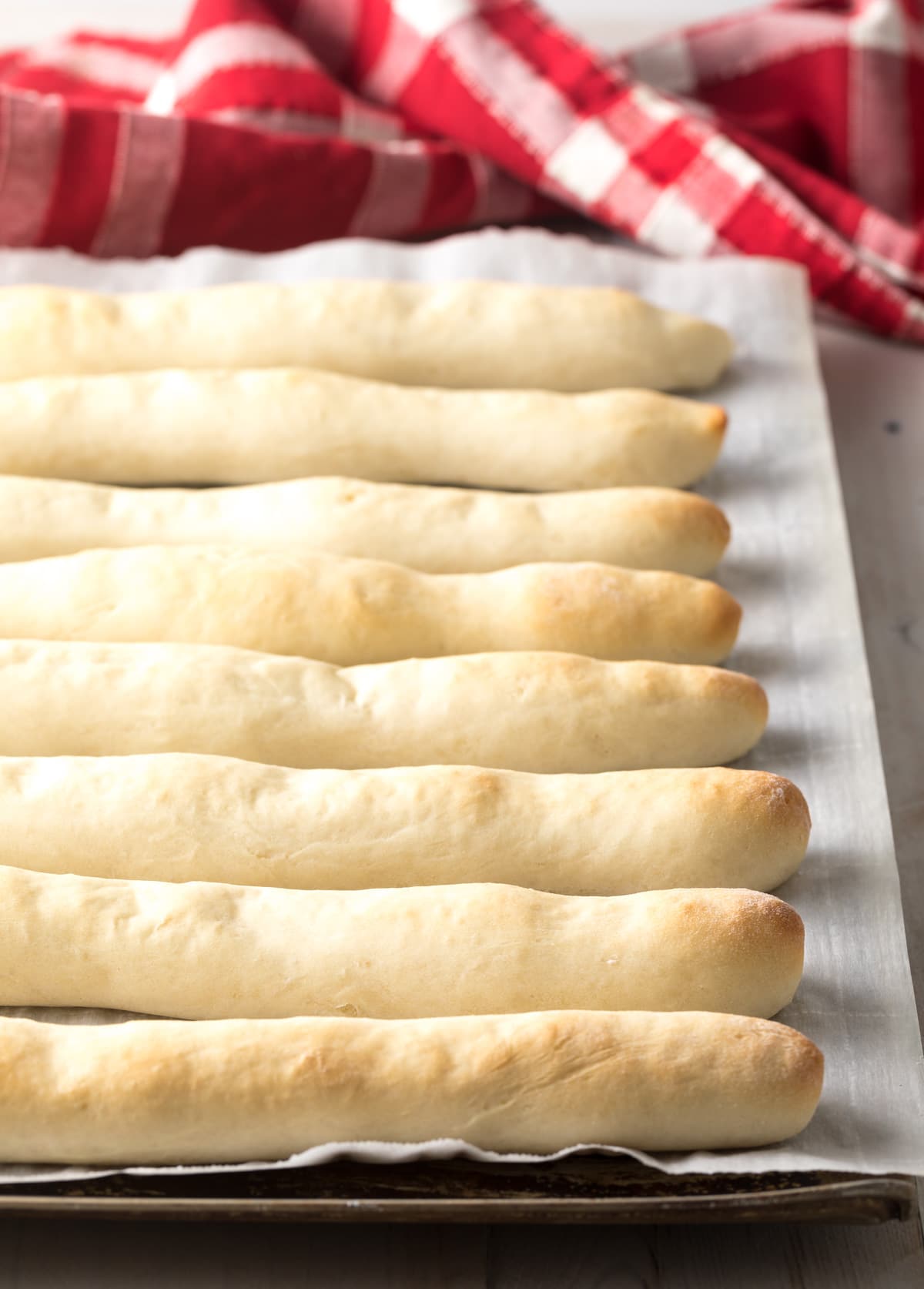 Baked bread sticks on a baking dish fresh out of the oven.