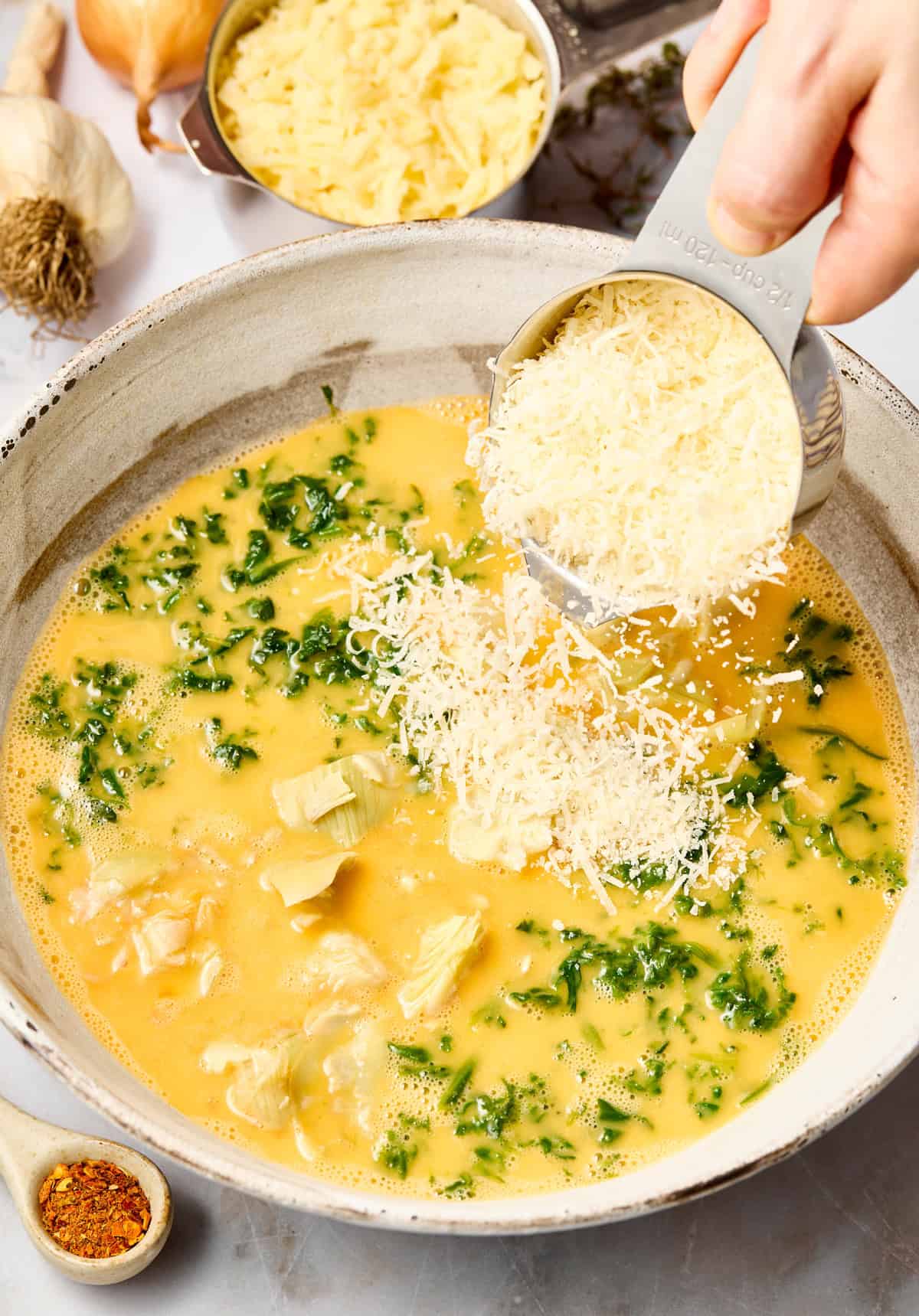 Mixing ingredients for spinach artichoke casserole