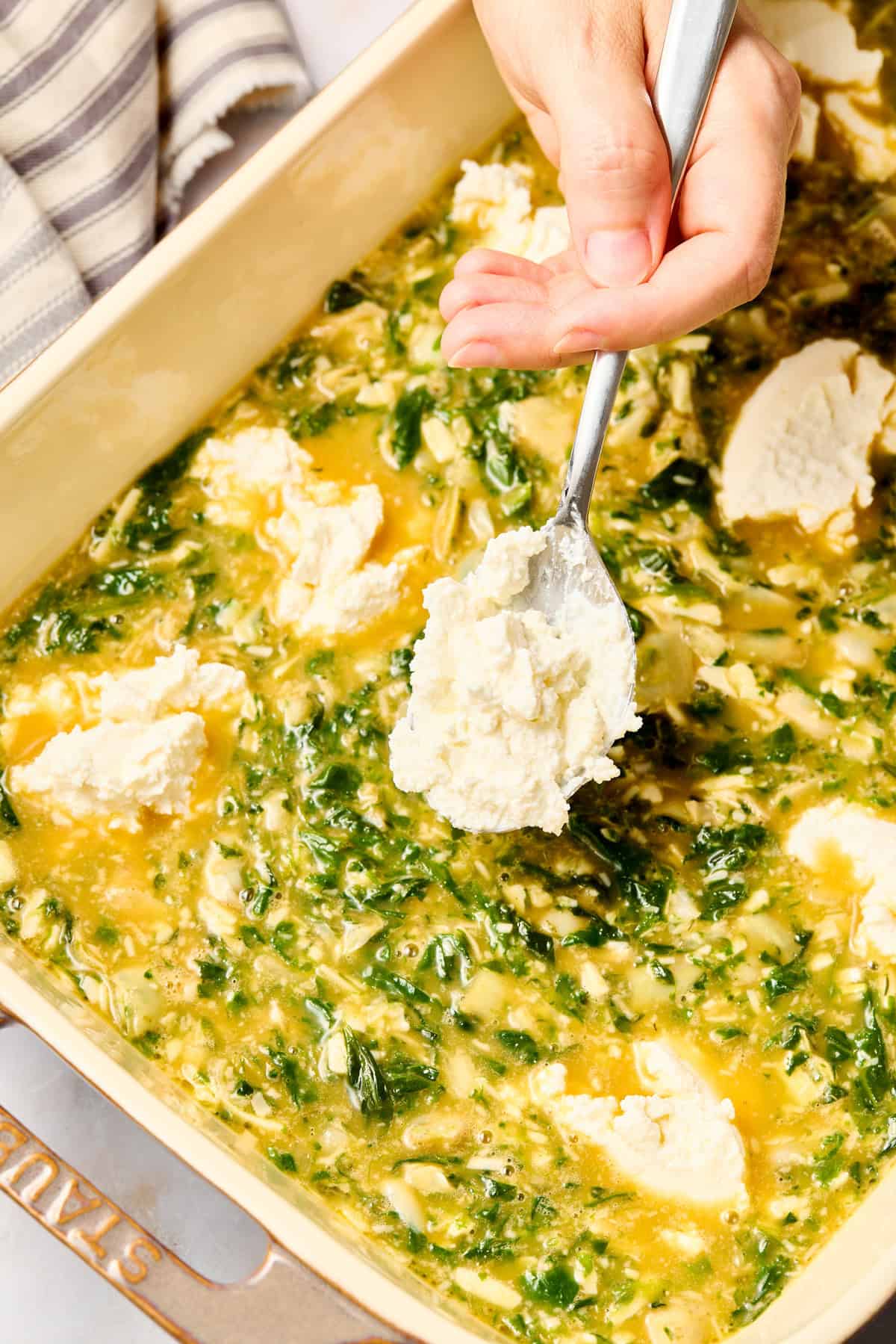 Artichoke Egg Casserole going in baking dish