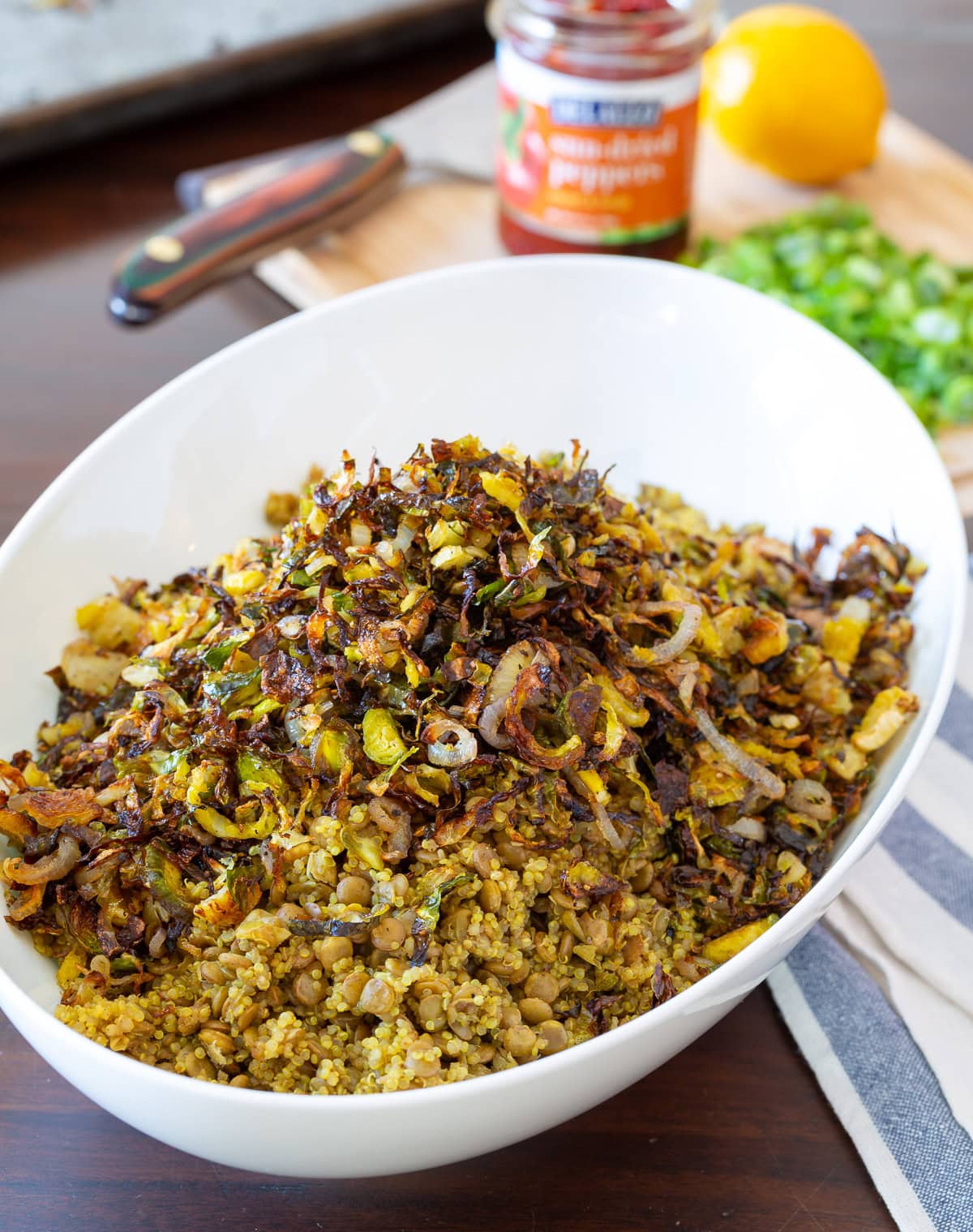 quinoa lentil salad.  Top photo of quinoa, lentils and brussels sprouts in a white bowl.  