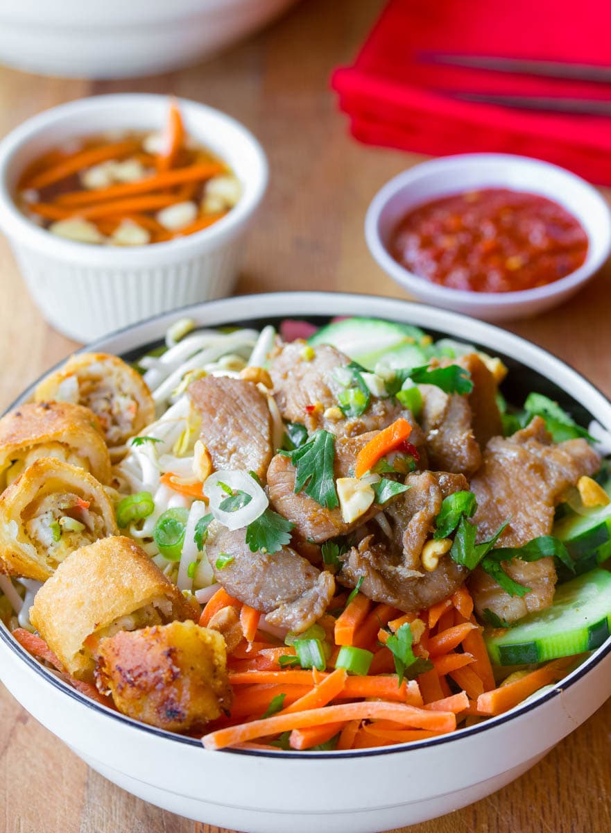 Cha Gio #ASpicyPerspective #BunCha #ChaGio #BunChaGio #BunChaRecipe #Vietnamese #SaladBowl Bun Cha in a bowl with sauces in the background.