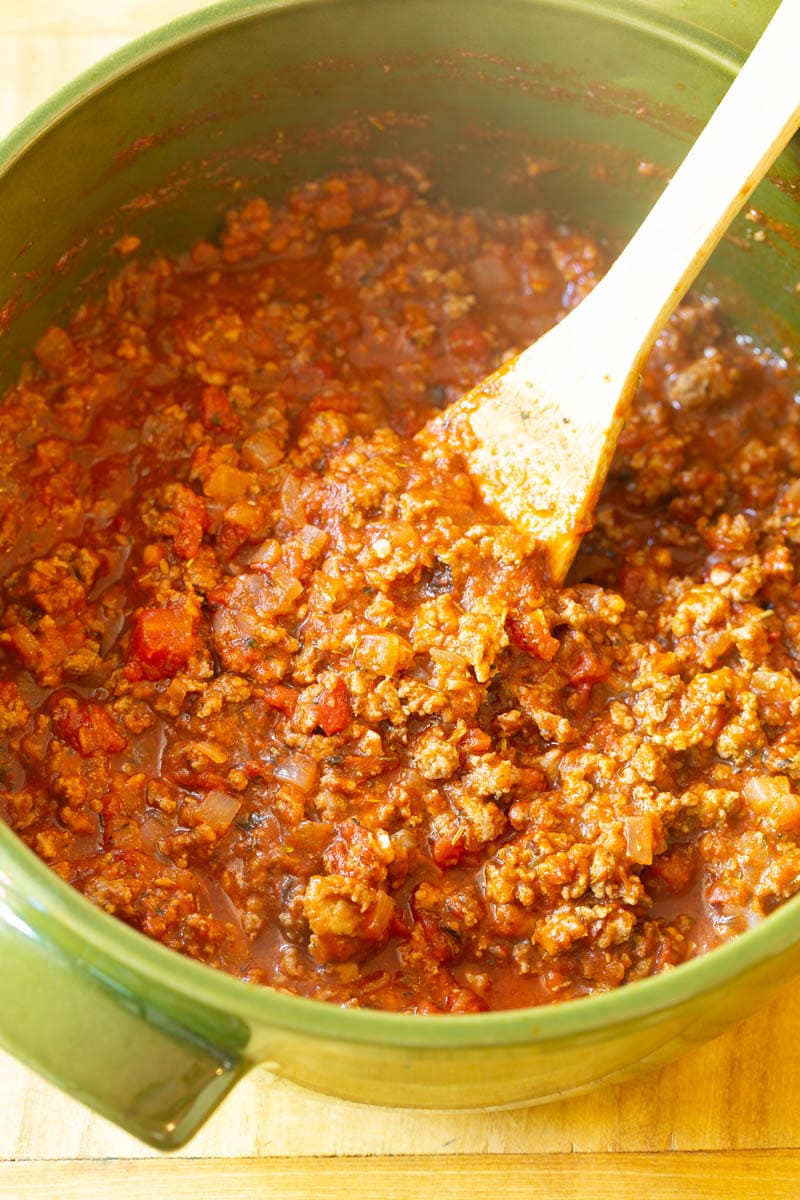 Meat sauce being cooked in pan.