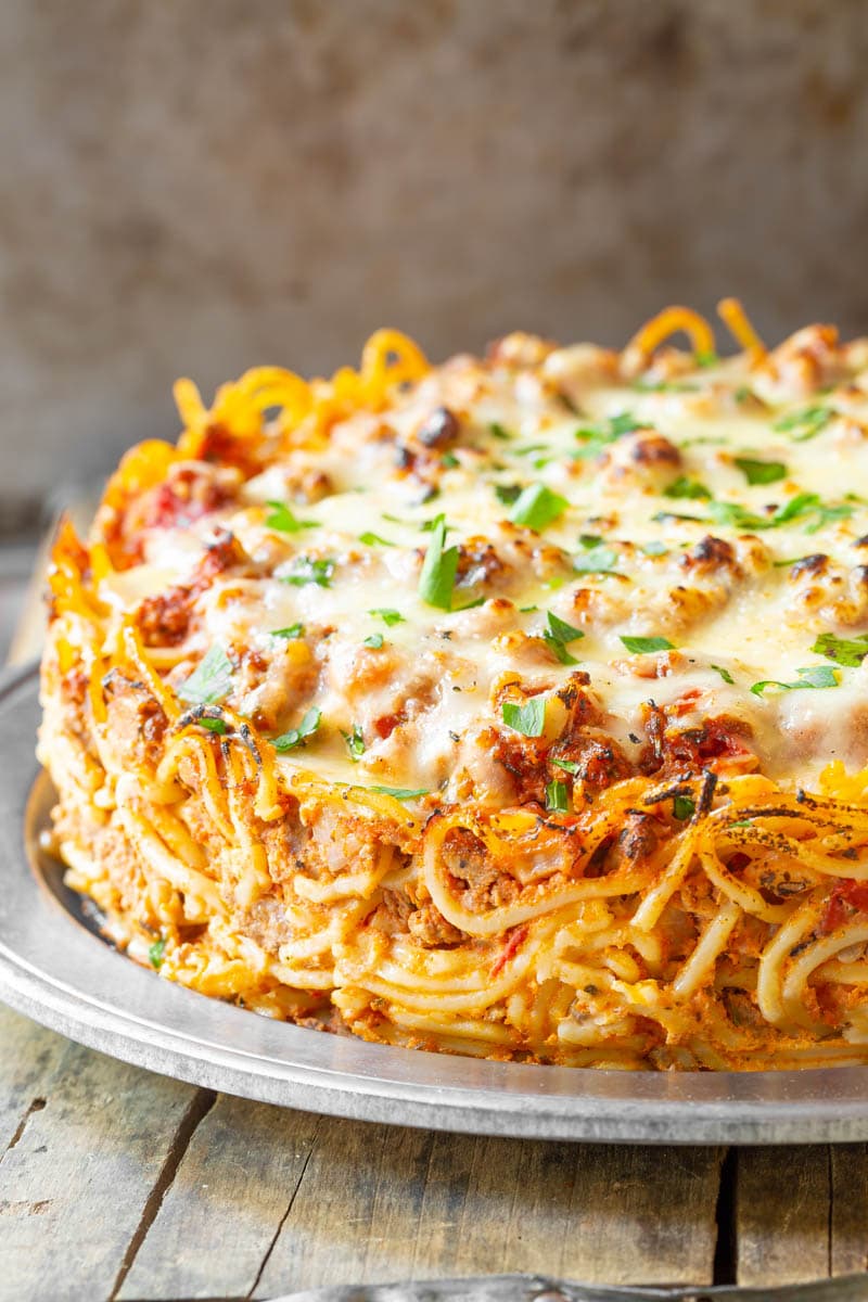 Baked Spaghetti Pie Recipe #ASpicyPerspective #Spaghetti #SpaghettiPie #SpaghettiPieRecipe #BakedSpaghetti #BakedSpaghettiPie #BakedSpaghettiPieRecipe #Dinner #Pasta #MainDish #Italian Close up of baked spaghetti pie.