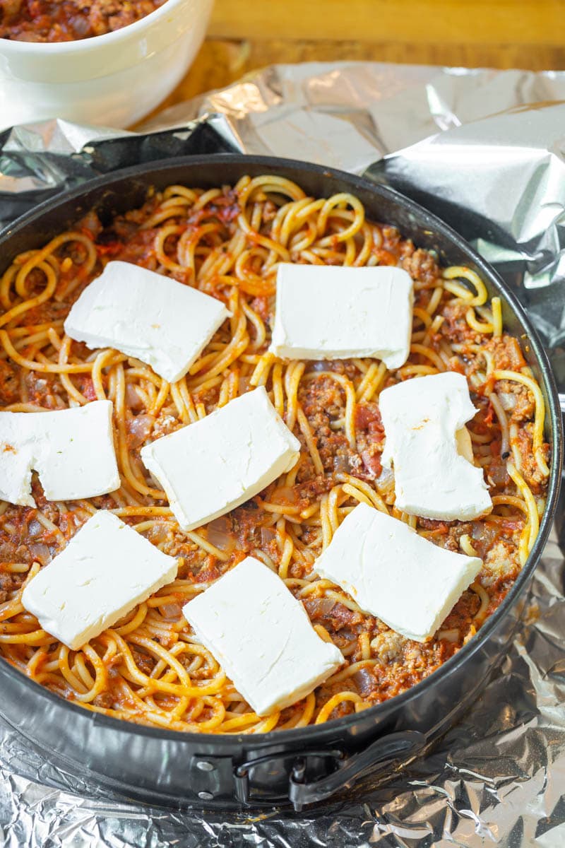 Spaghetti pie topped off with cream cheese.