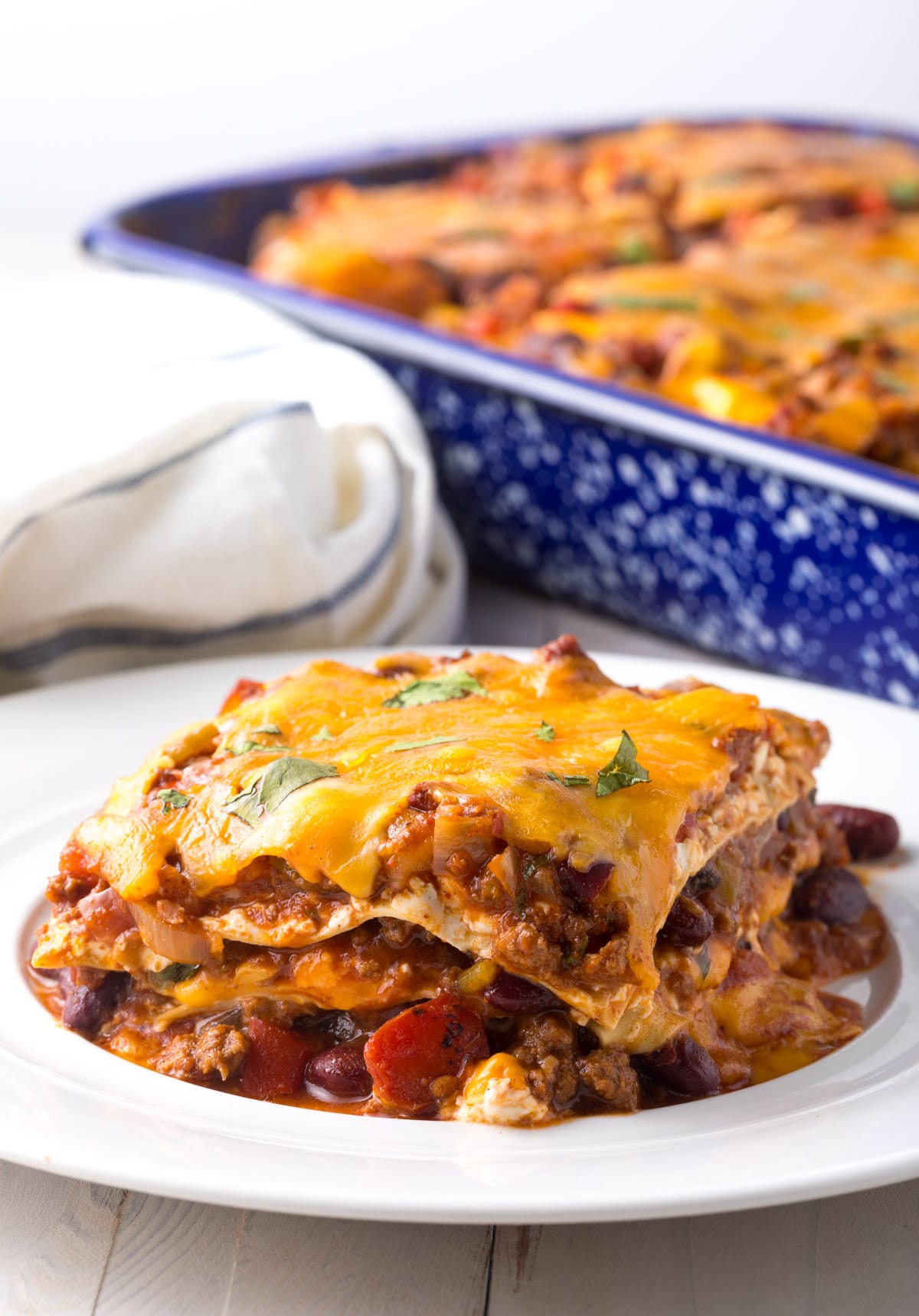 Pasta and cowboy chili layered in a casserole dish.