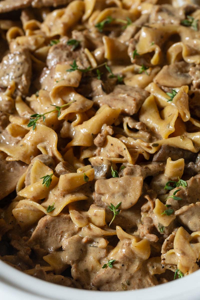 Slow Cooker Beef Stroganoff #ASpicyPerspective #Beef #Stroganoff #BeefStroganoff #BeefStroganoffRecipe #SlowCookerBeefStroganoff #BeefStroganoffCrockpot #SlowCooker #Crockpot Slow Cooker Beef Stroganoff close up with noodles - close up version