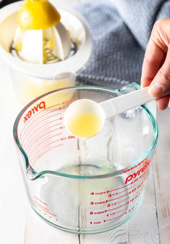 Using a glass measuring cup, add the lemon juice 
