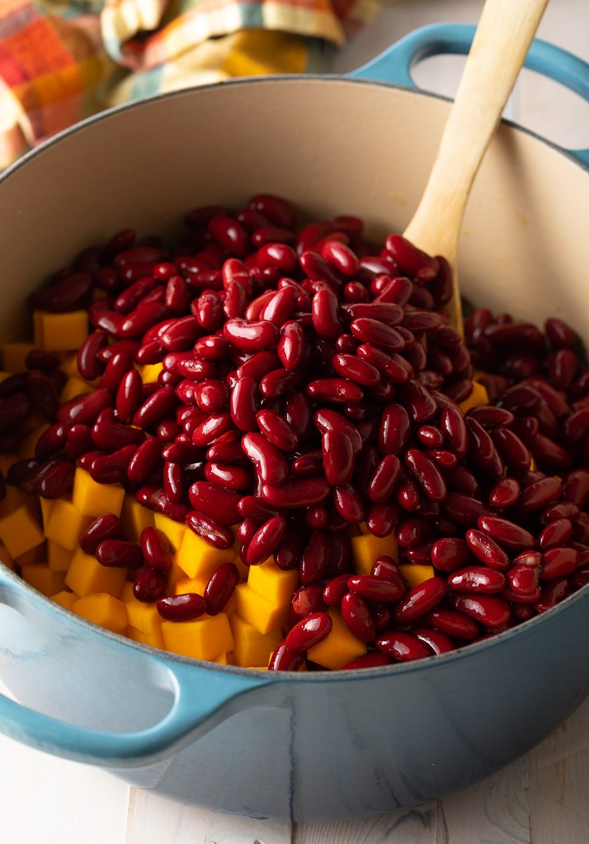 Beans being added into giant pot.