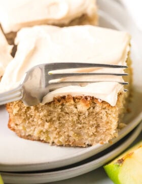 Best Ever Apple Cake with Salted Caramel Frosting - fork cutting into cake