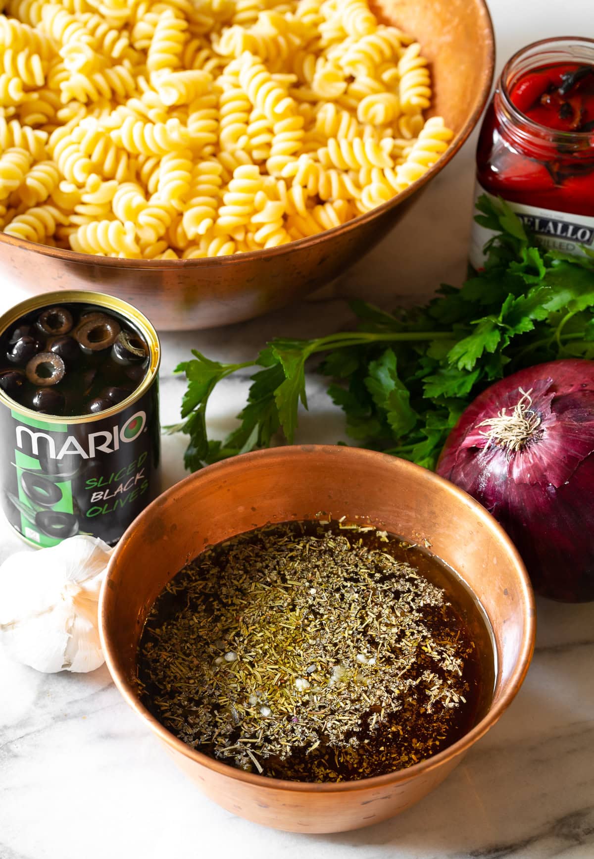 Dressing #ASpicyPerspective #PastaSalad #PastaSaladRecipe #ItalianPastaSalad #Italian #Salad #BestPastaSalad #Spring #Summer Pasta salad ingredients with dressing in a bowl.