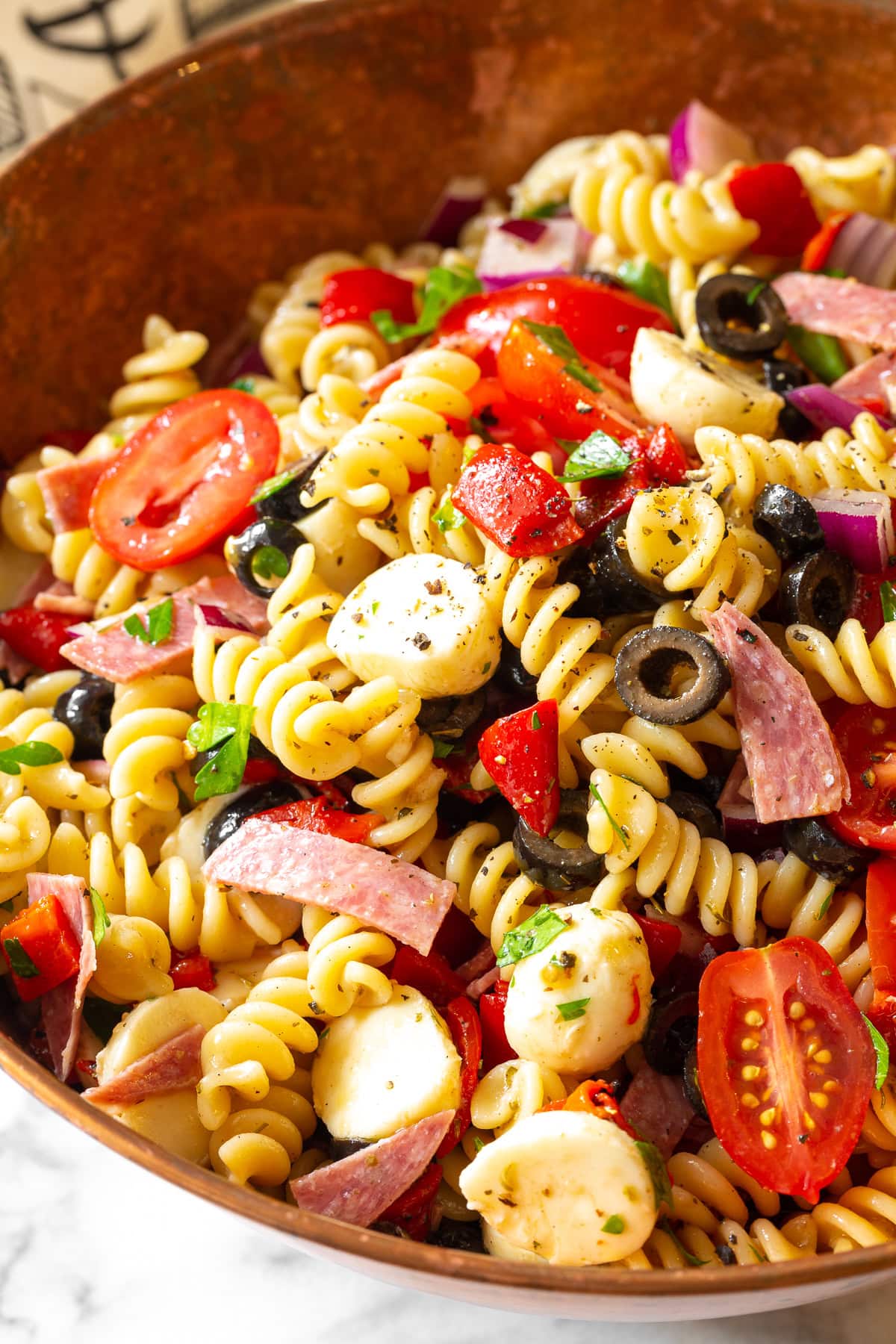 Overhead view of Italian pasta salat in a large serving bowl.