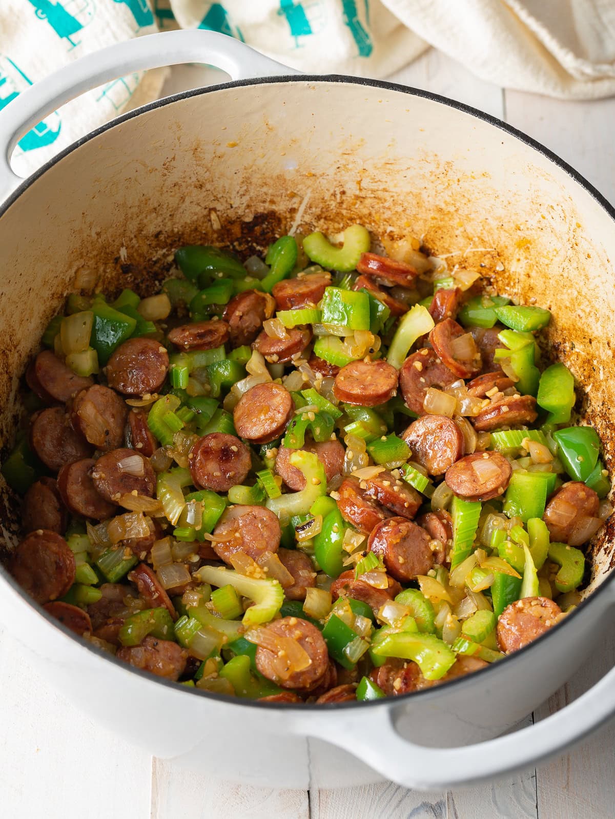 Large pot of sauteed sausage, peppers, and onions.