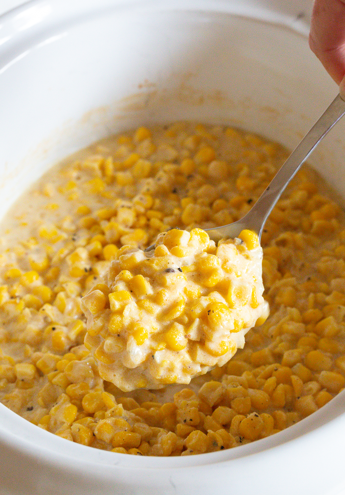 Slow Cooker Creamed Corn Recipe #ASpicyPerspective #corn #thanksgiving #holidays #southern #crockpot #slowcooker
